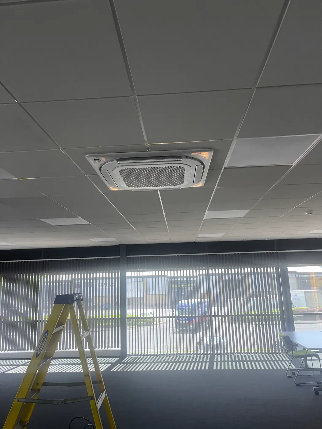 Commercial air conditioning by our Bolton engineers Recessed ceiling cassette air conditioner in a commercial office