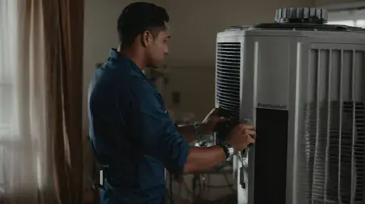 HVAC servicing in Manchester Engineer servicing an indoor HVAC unit